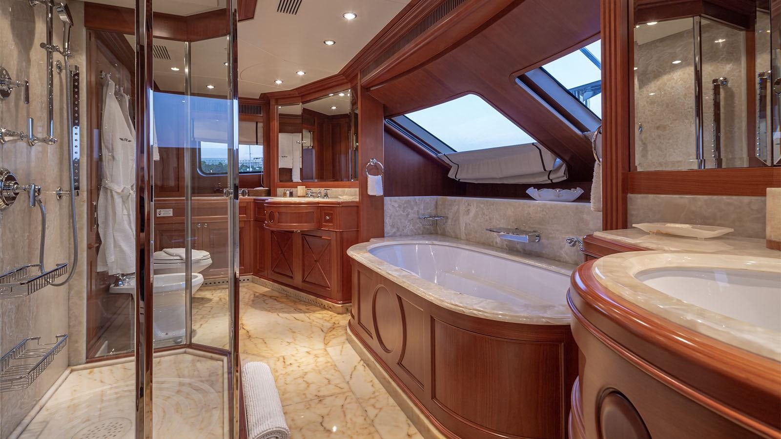 a bathroom with a tub and shower aboard RIVA I Yacht for Sale