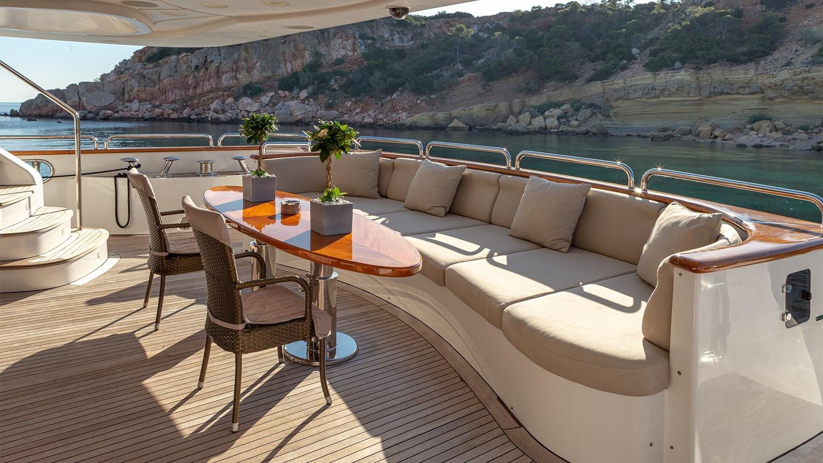 a table and chairs on a balcony aboard RIVA I Yacht for Sale