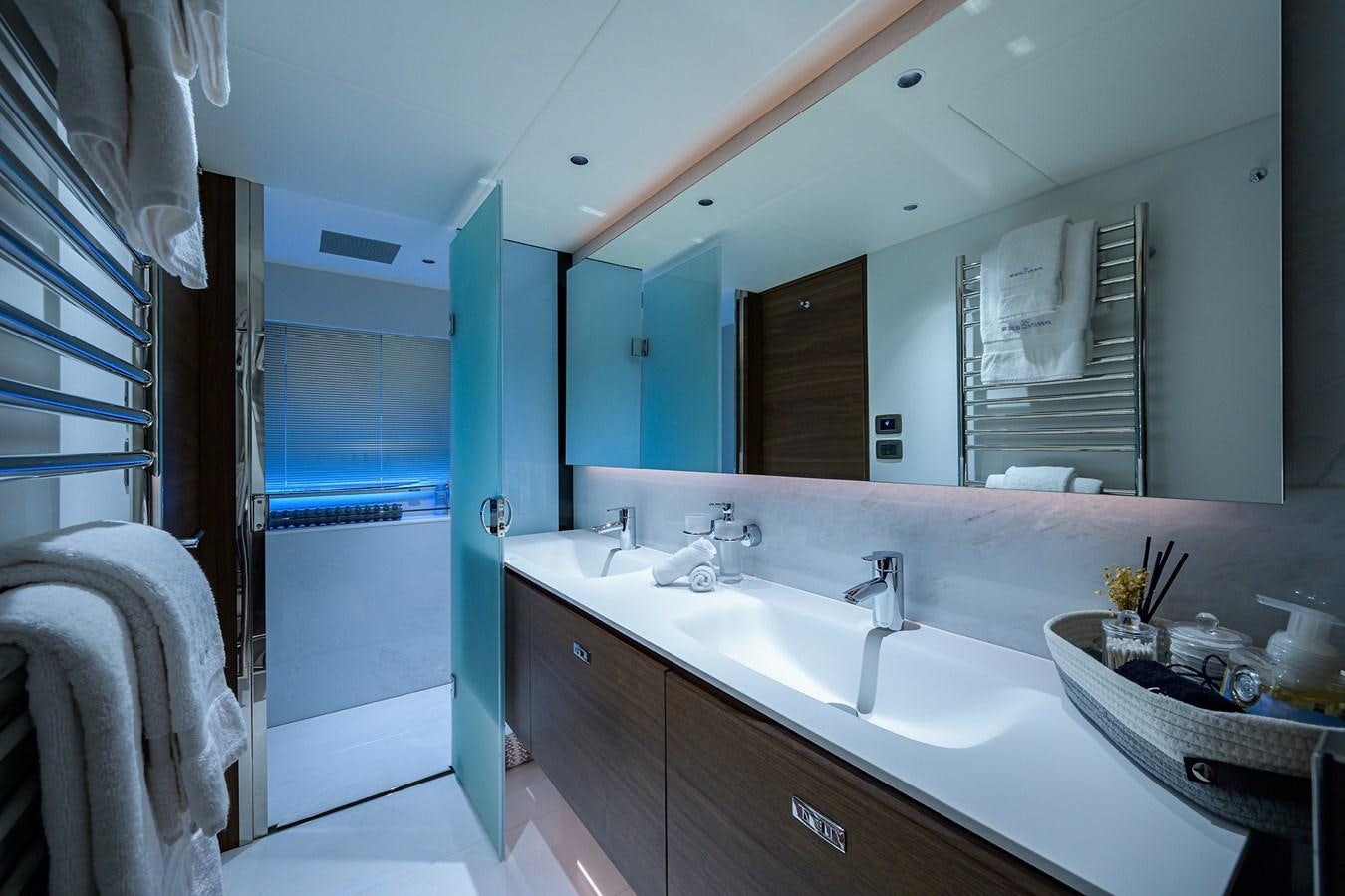 a bathroom with a large mirror aboard ESCAPE Yacht for Sale