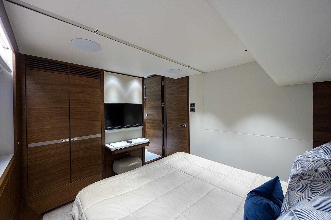 a room with a bed and a desk aboard ESCAPE Yacht for Sale