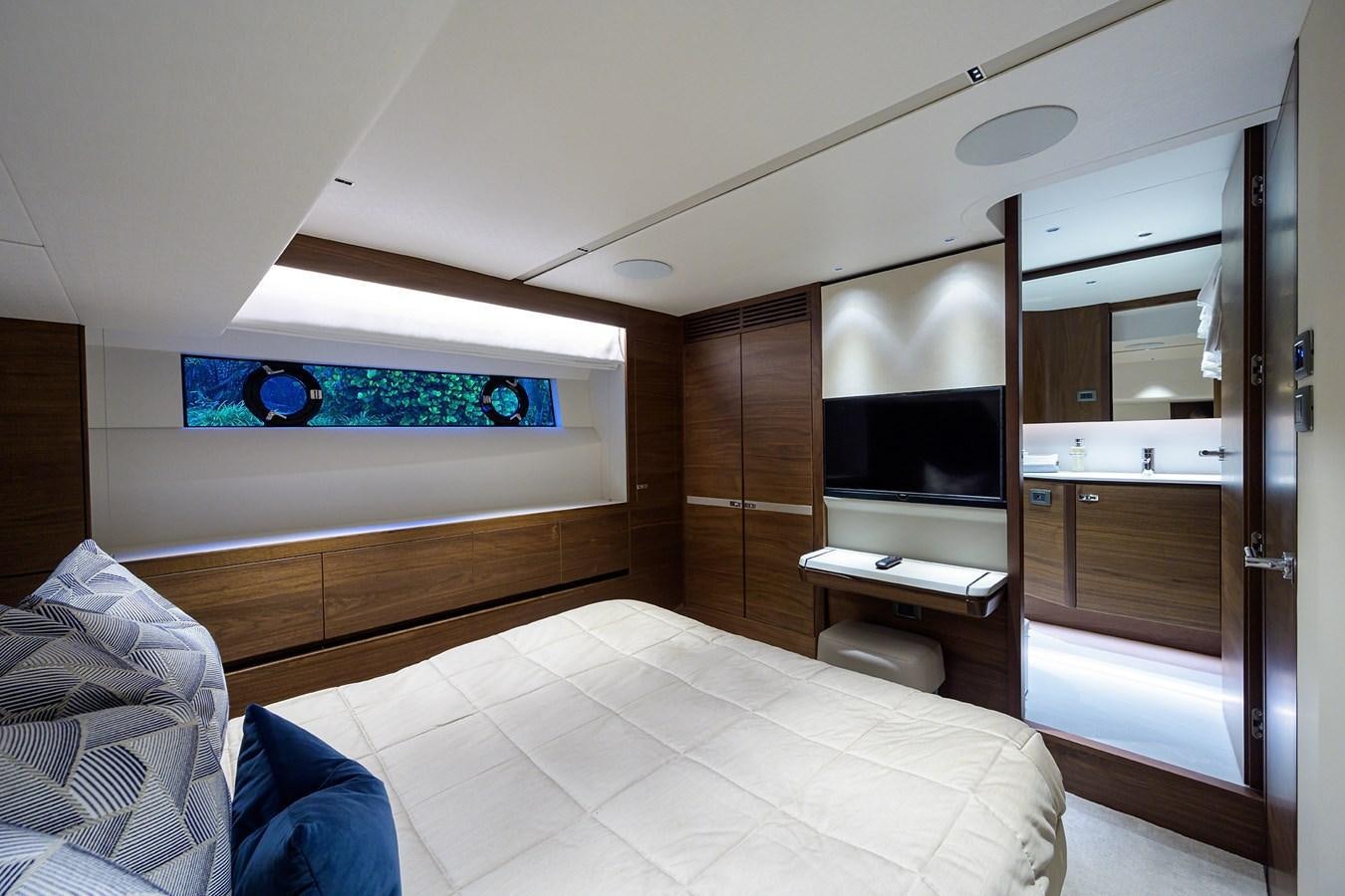 a room with a bed and a desk aboard ESCAPE Yacht for Sale