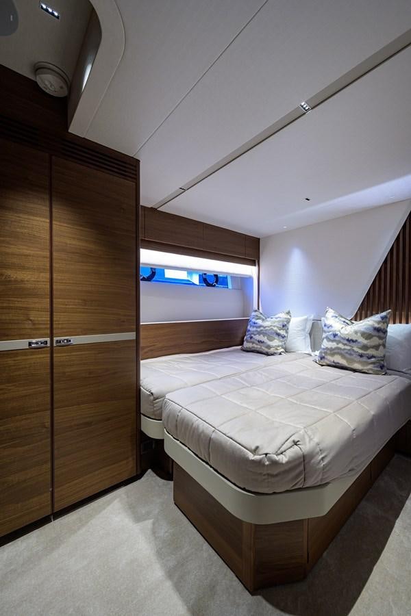 a room with a bed and a closet aboard ESCAPE Yacht for Sale