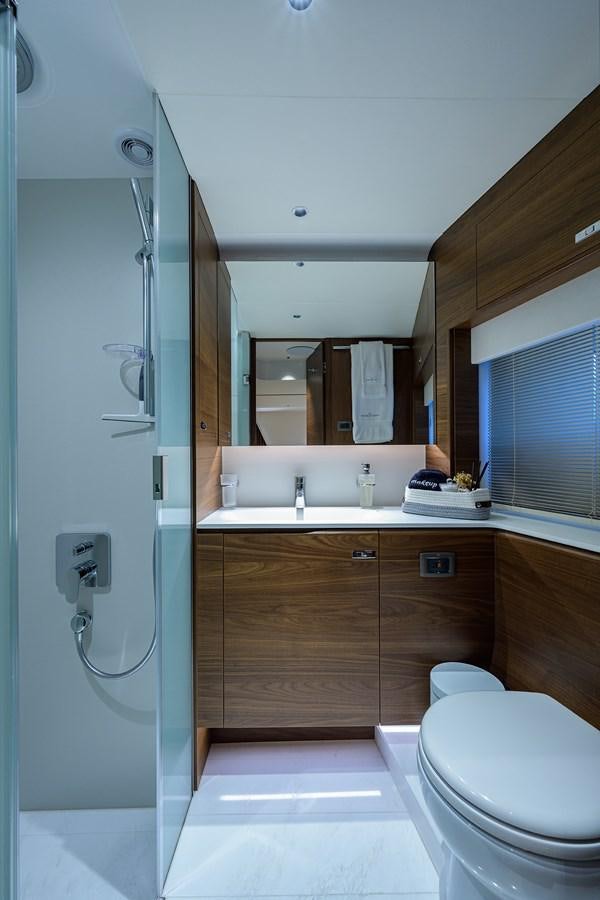 a bathroom with a toilet and a sink aboard ESCAPE Yacht for Sale