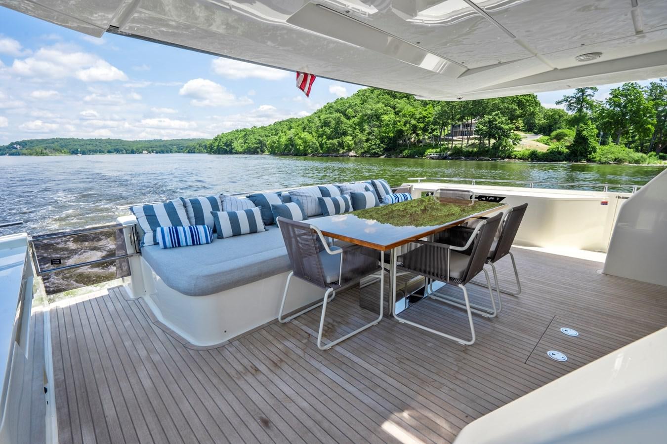 a table and chairs on a deck aboard PINCH ME Yacht for Sale