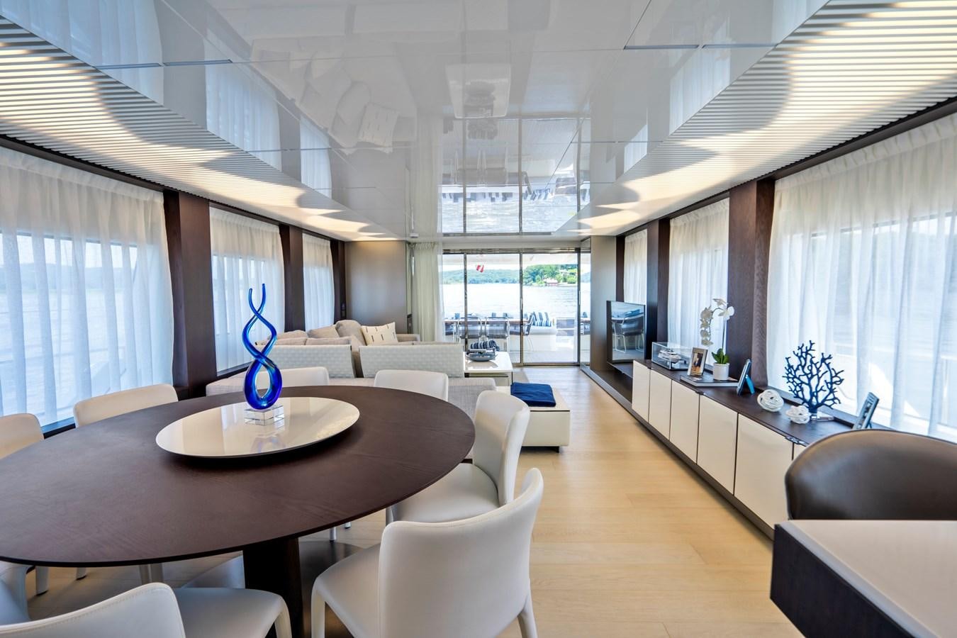 a room with a table chairs and a window aboard PINCH ME Yacht for Sale