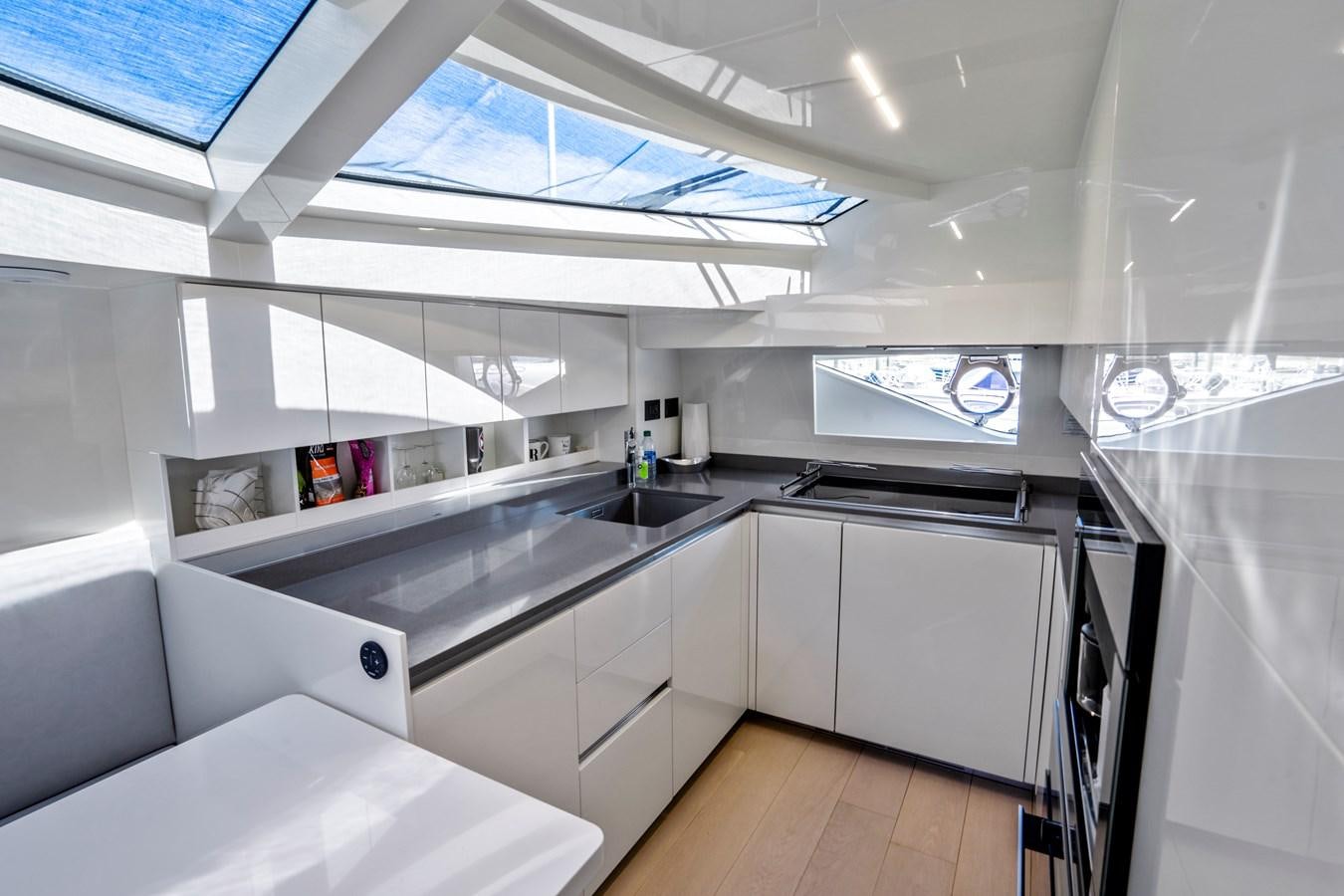 a kitchen with white cabinets aboard PINCH ME Yacht for Sale