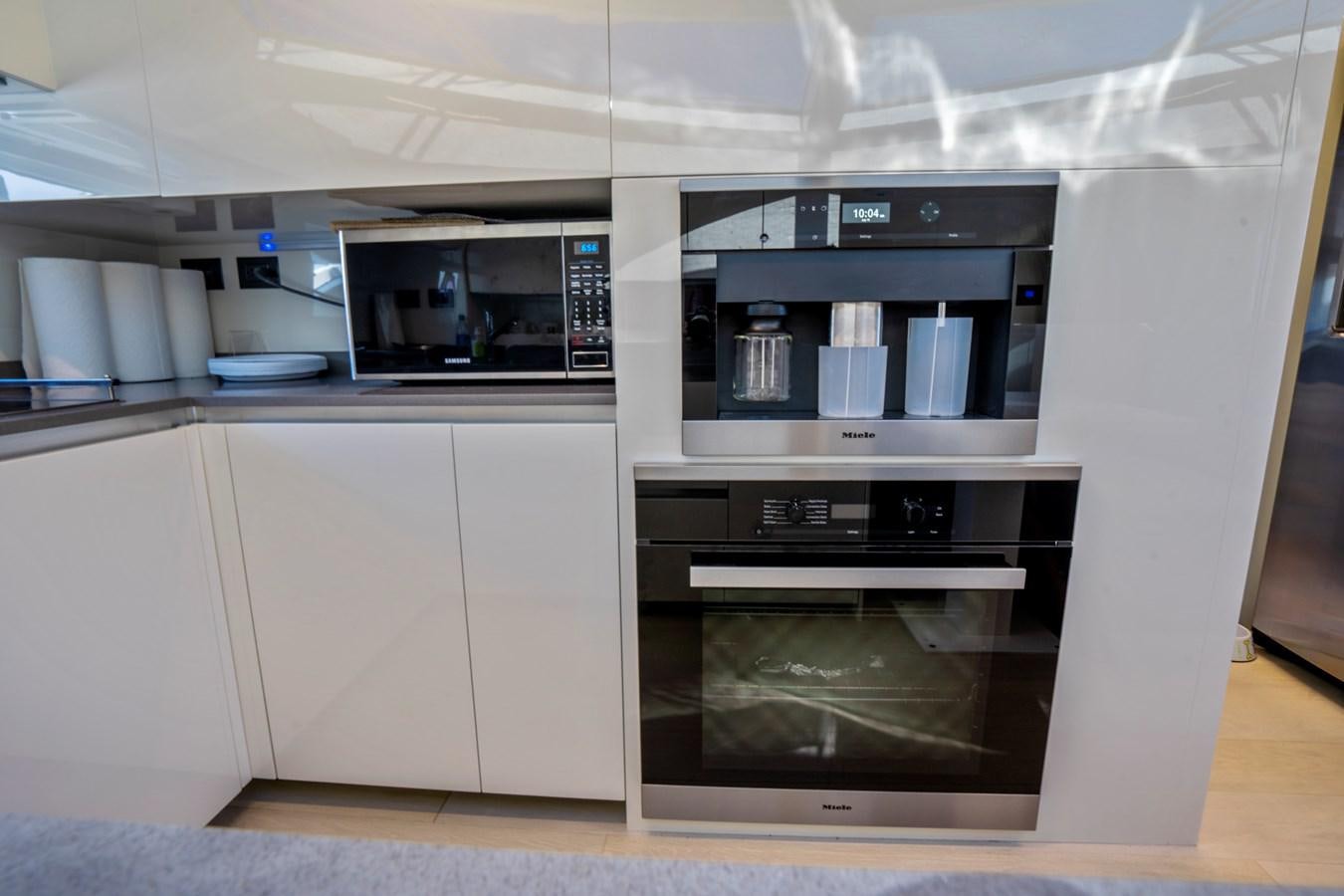 a kitchen with a stove and oven aboard PINCH ME Yacht for Sale