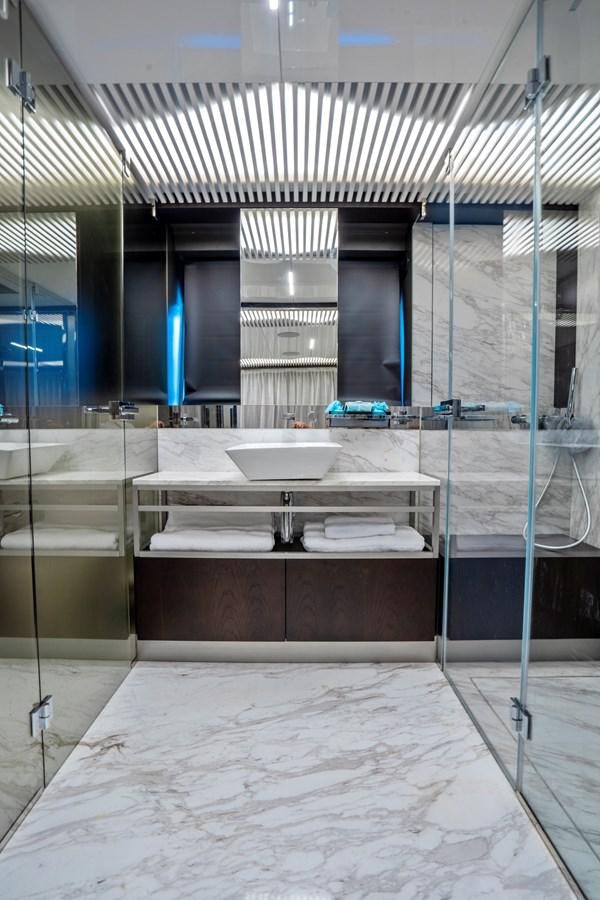 a bathroom with a sink and a large mirror aboard PINCH ME Yacht for Sale