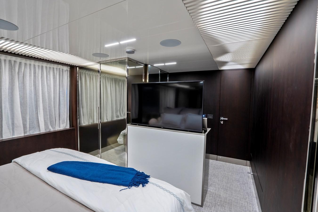 a room with a bed and a television aboard PINCH ME Yacht for Sale
