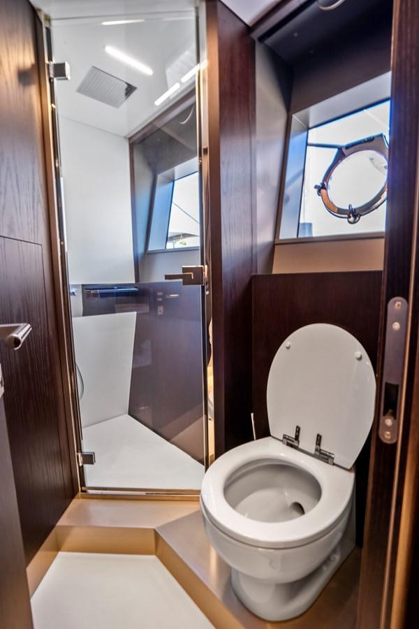 a bathroom with a toilet and a mirror aboard PINCH ME Yacht for Sale