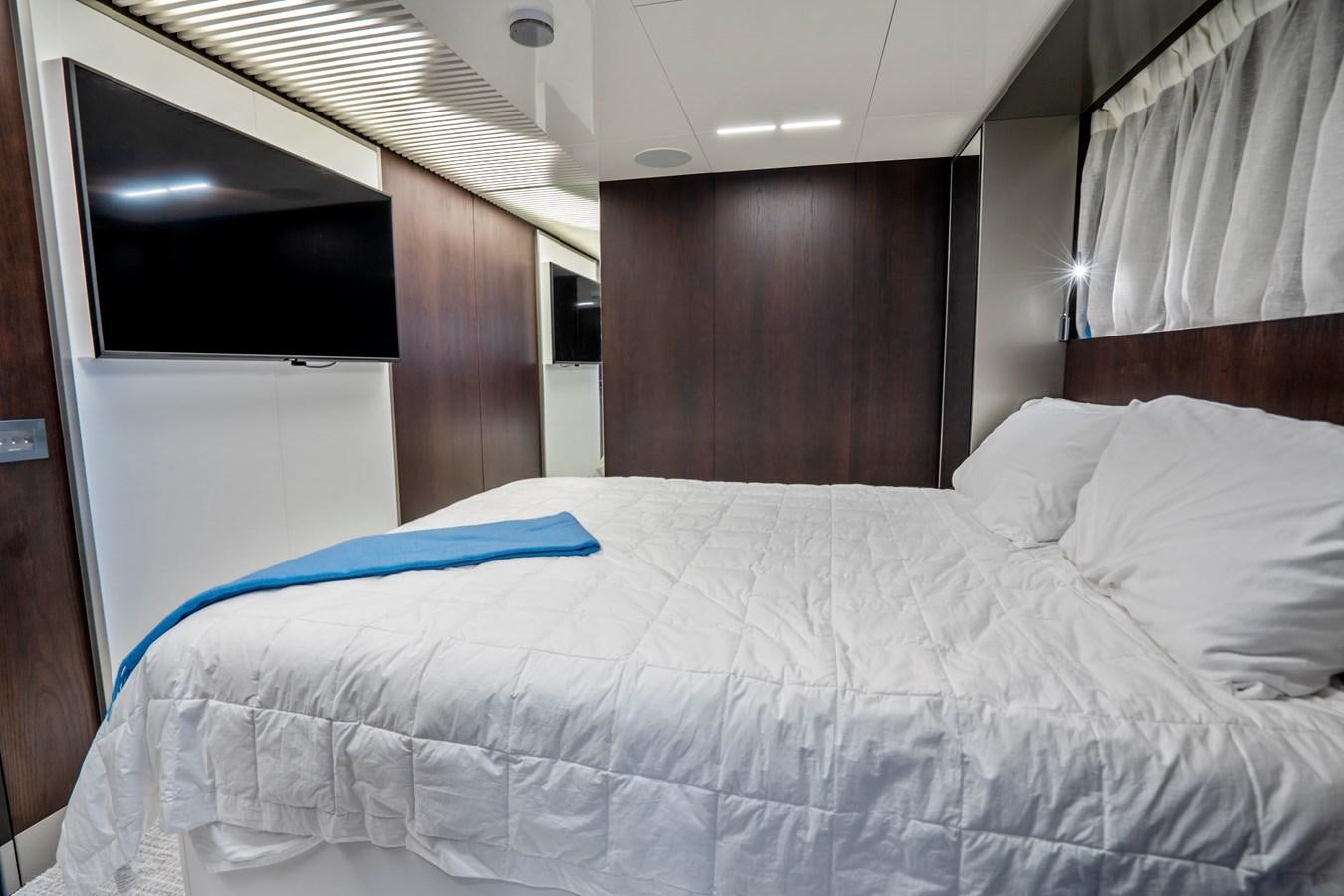 a bed with a blue sheet aboard PINCH ME Yacht for Sale