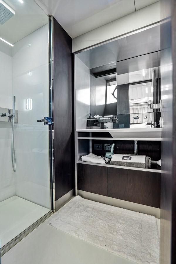 a large bathroom with a glass shower aboard PINCH ME Yacht for Sale