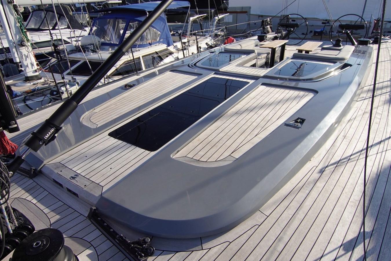 a white boat on a dock aboard NYUMBA Yacht for Sale