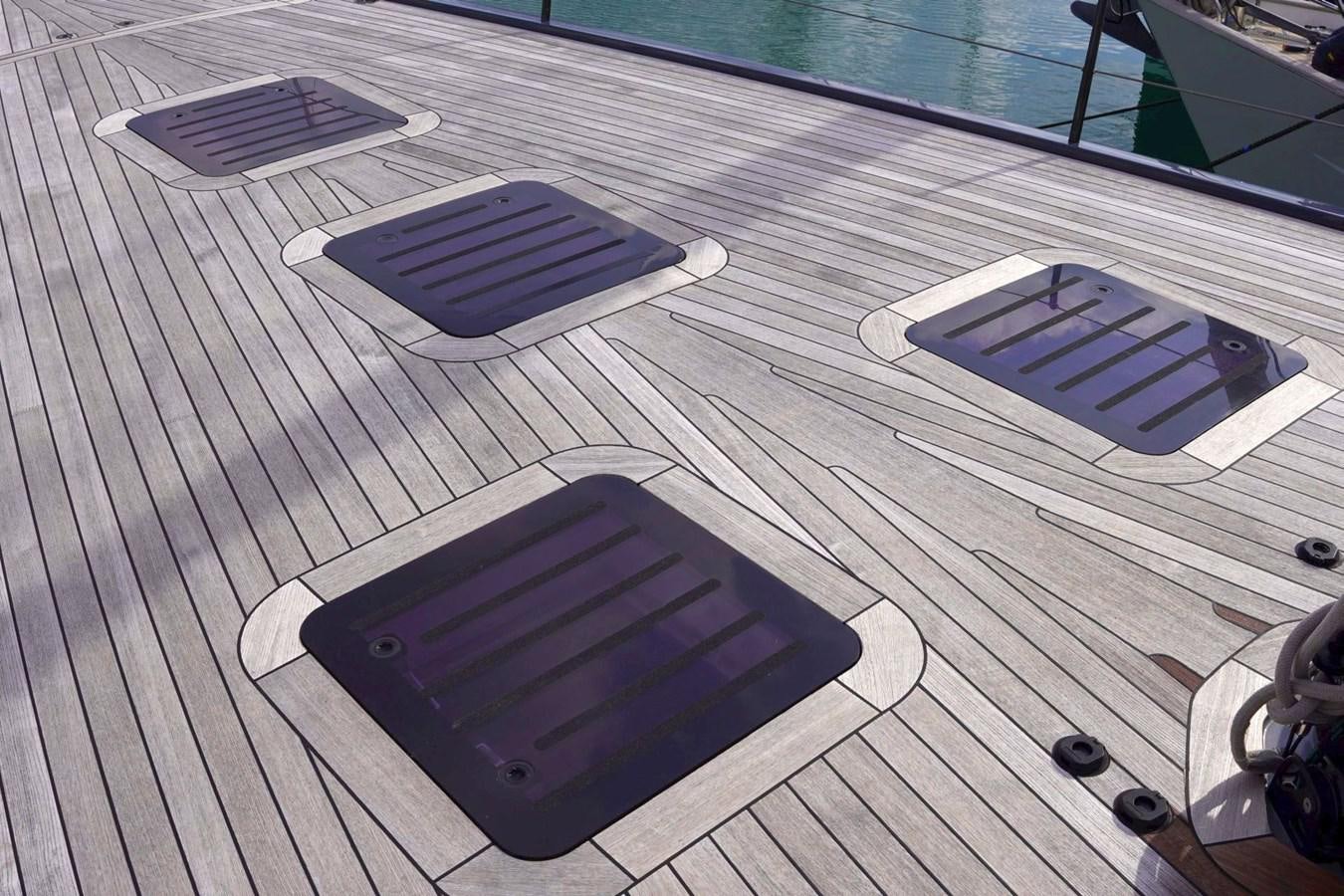 a group of electronic devices on a table aboard NYUMBA Yacht for Sale