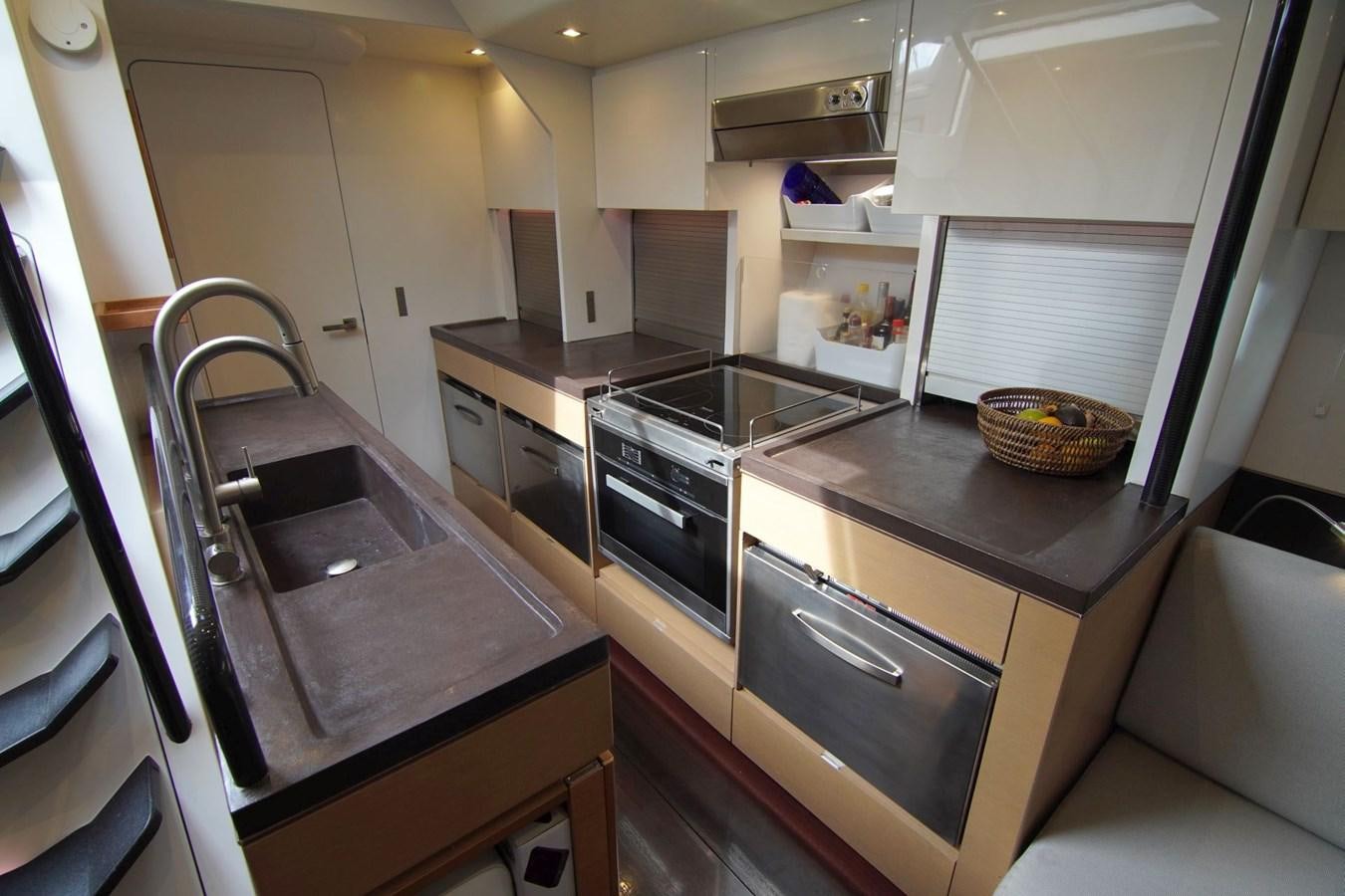 a kitchen with a sink and a stove aboard NYUMBA Yacht for Sale