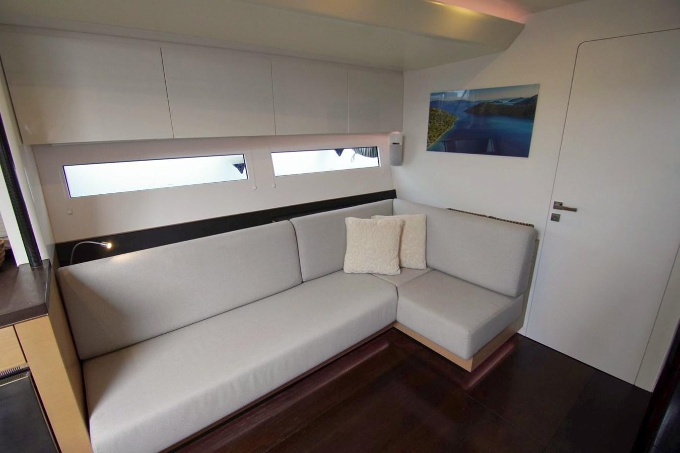 a white couch in a room aboard NYUMBA Yacht for Sale
