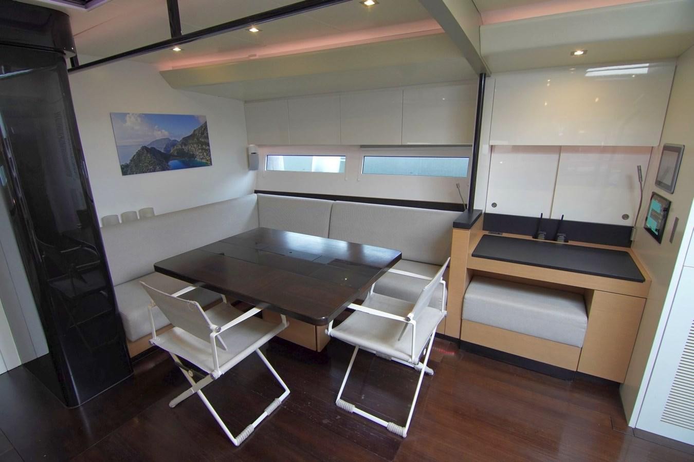 a room with a table and chairs aboard NYUMBA Yacht for Sale