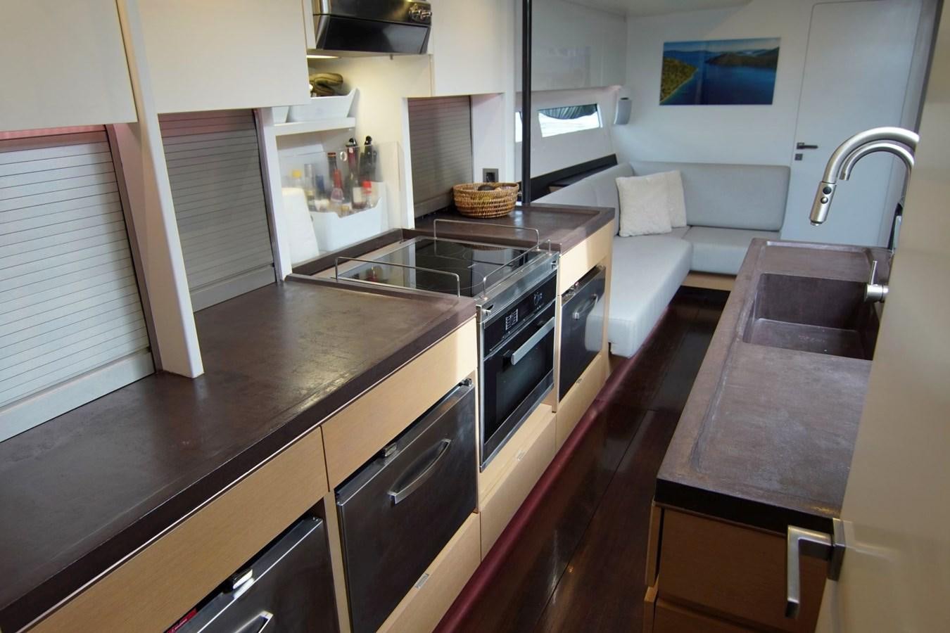 a kitchen with a stove and a sink aboard NYUMBA Yacht for Sale
