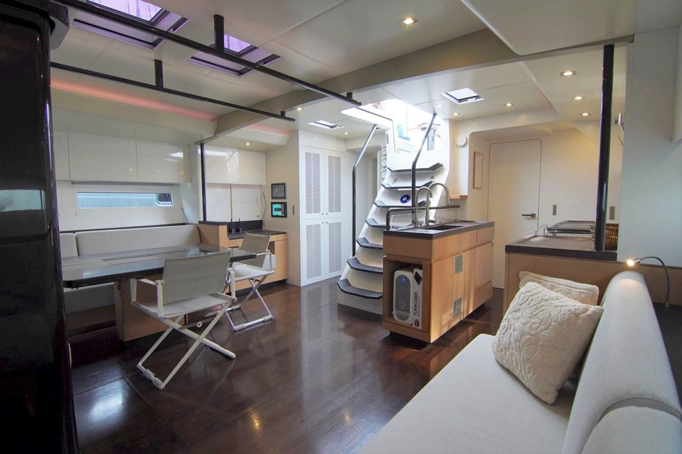 a room with a bed and desk aboard NYUMBA Yacht for Sale