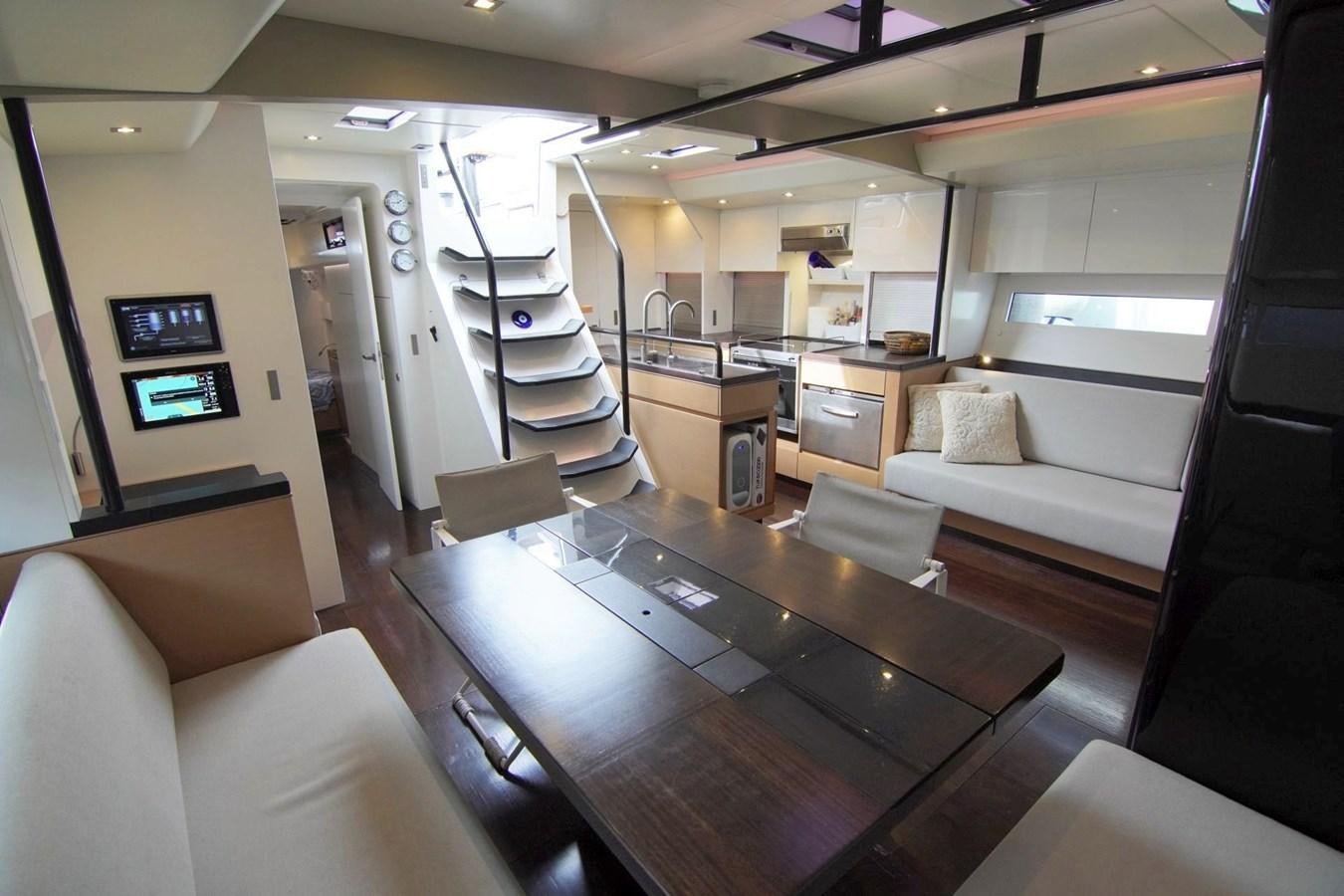 a room with a table and couches aboard NYUMBA Yacht for Sale
