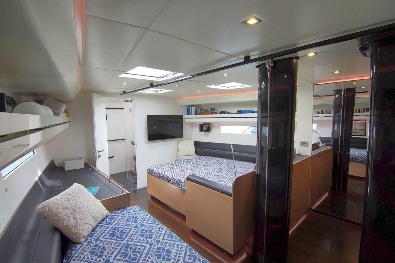 a room with a couch and a television aboard NYUMBA Yacht for Sale