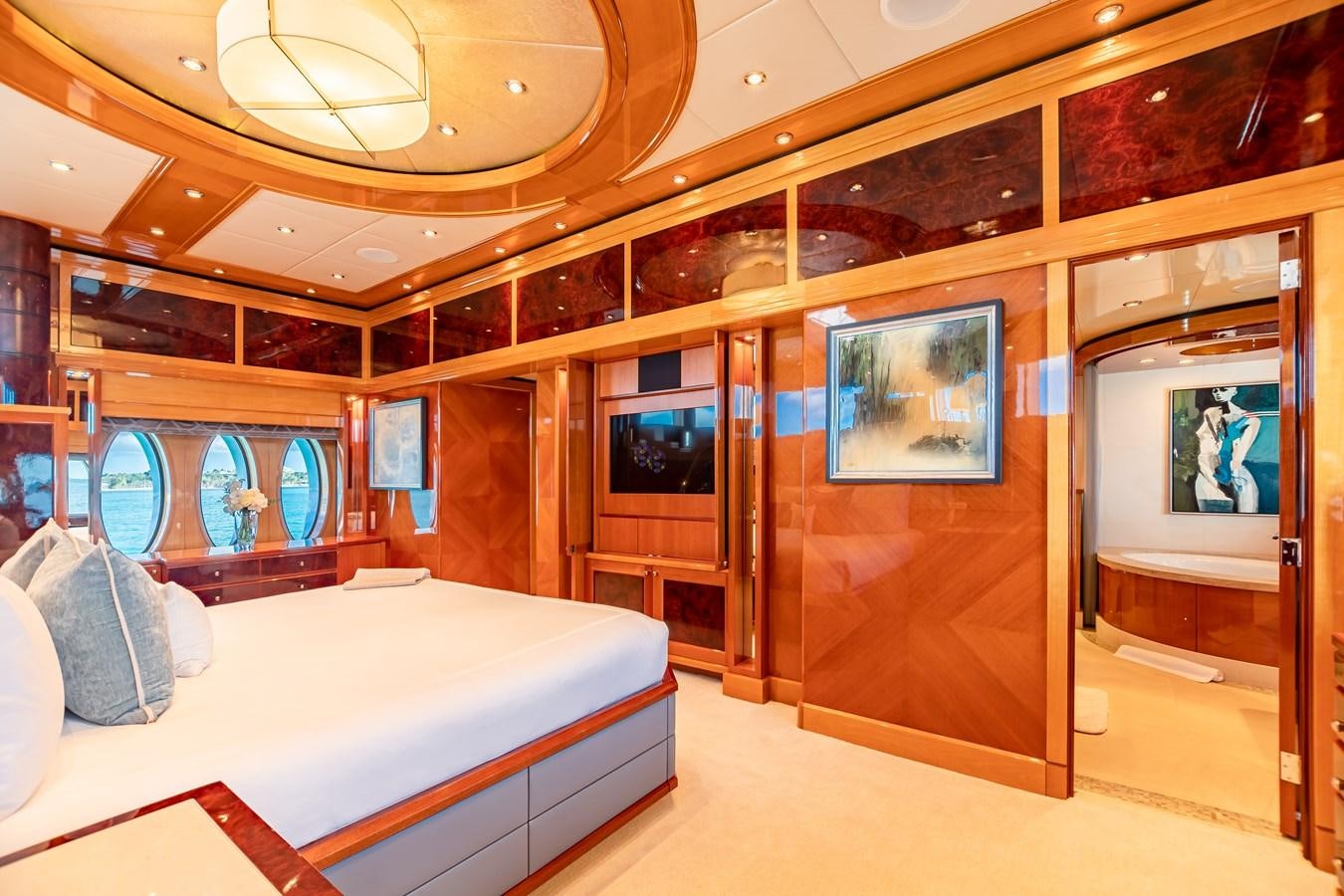 a room with a bed and a large mirror aboard IMPROMPTU Yacht for Charter