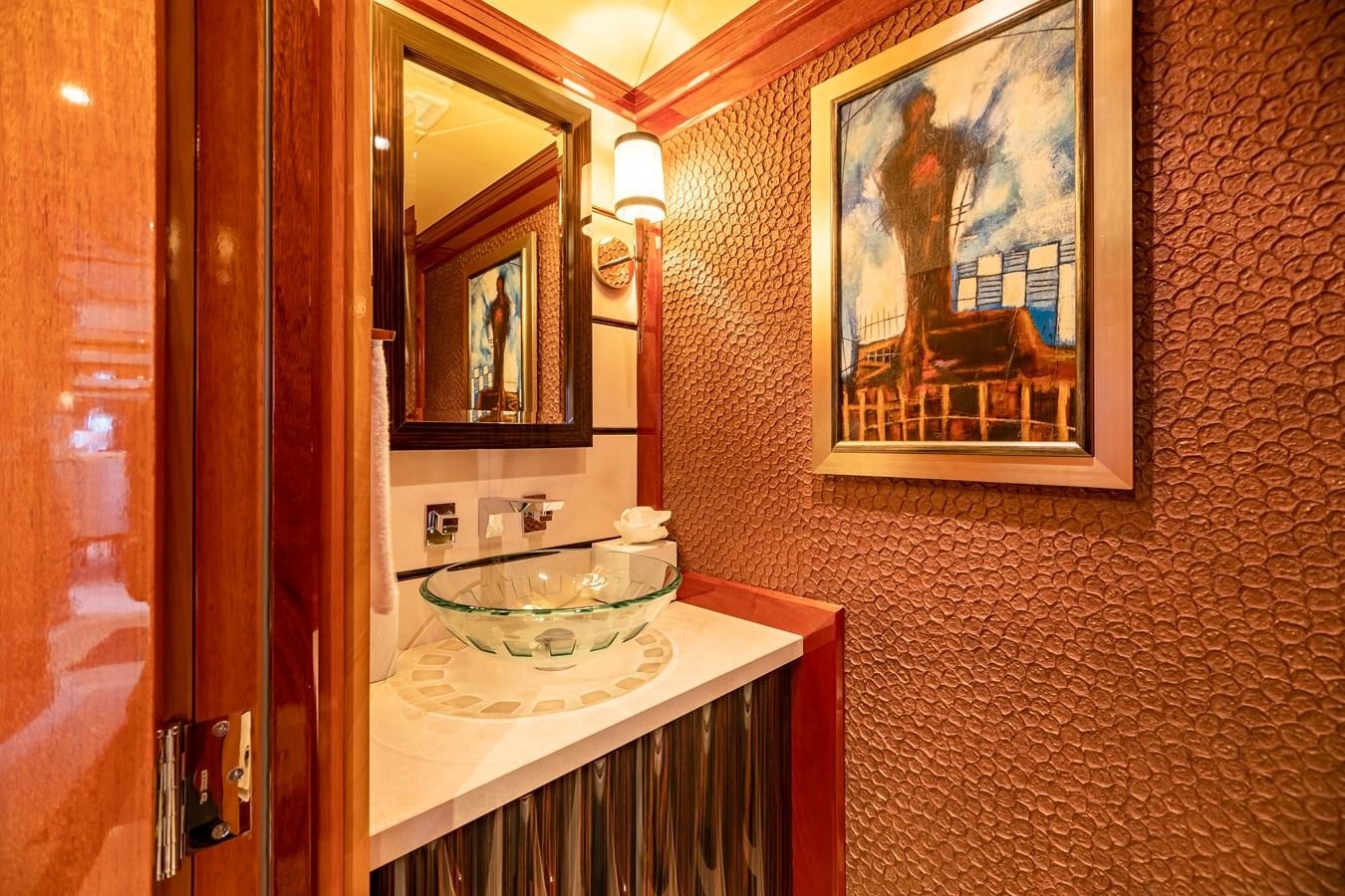 a bathroom with a sink and mirror aboard IMPROMPTU Yacht for Charter