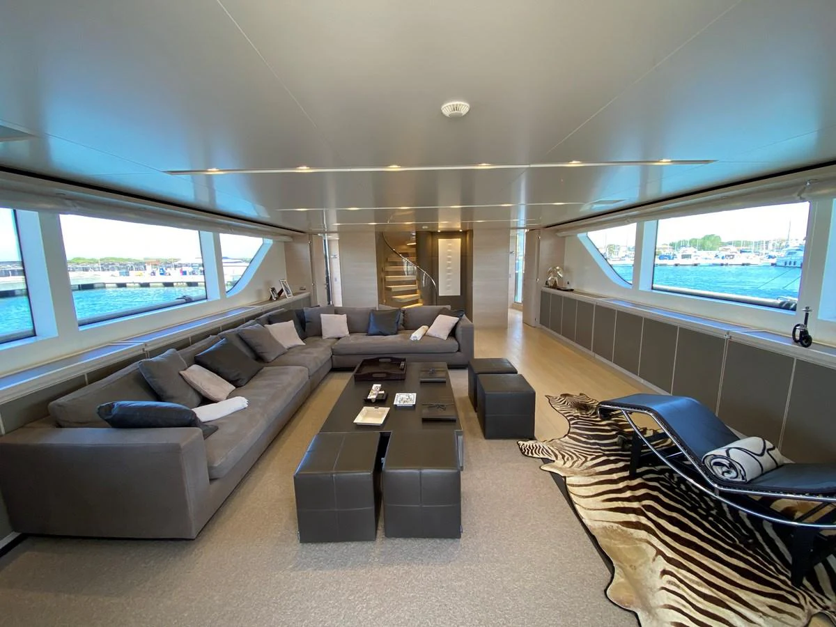 a living room with a couch and a table aboard NYALA OF AFRICA Yacht for Sale