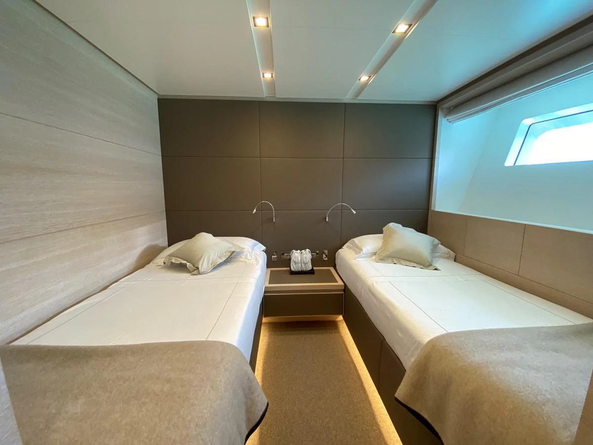 a room with beds and a window aboard NYALA OF AFRICA Yacht for Sale