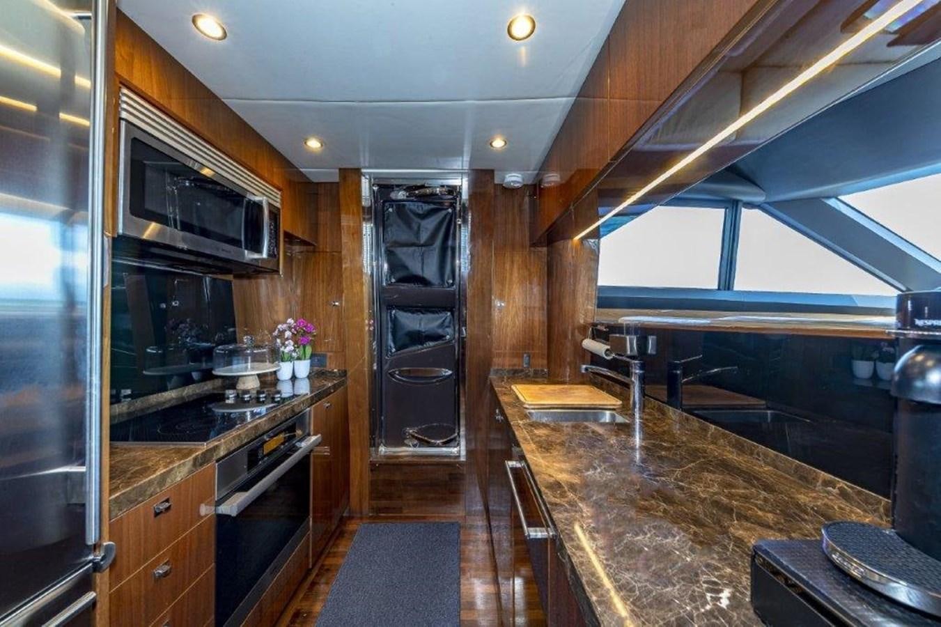 a kitchen with a large island aboard SIMPLER Yacht for Sale