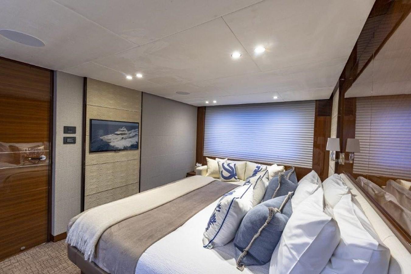 a bedroom with a bed and a door aboard SIMPLER Yacht for Sale