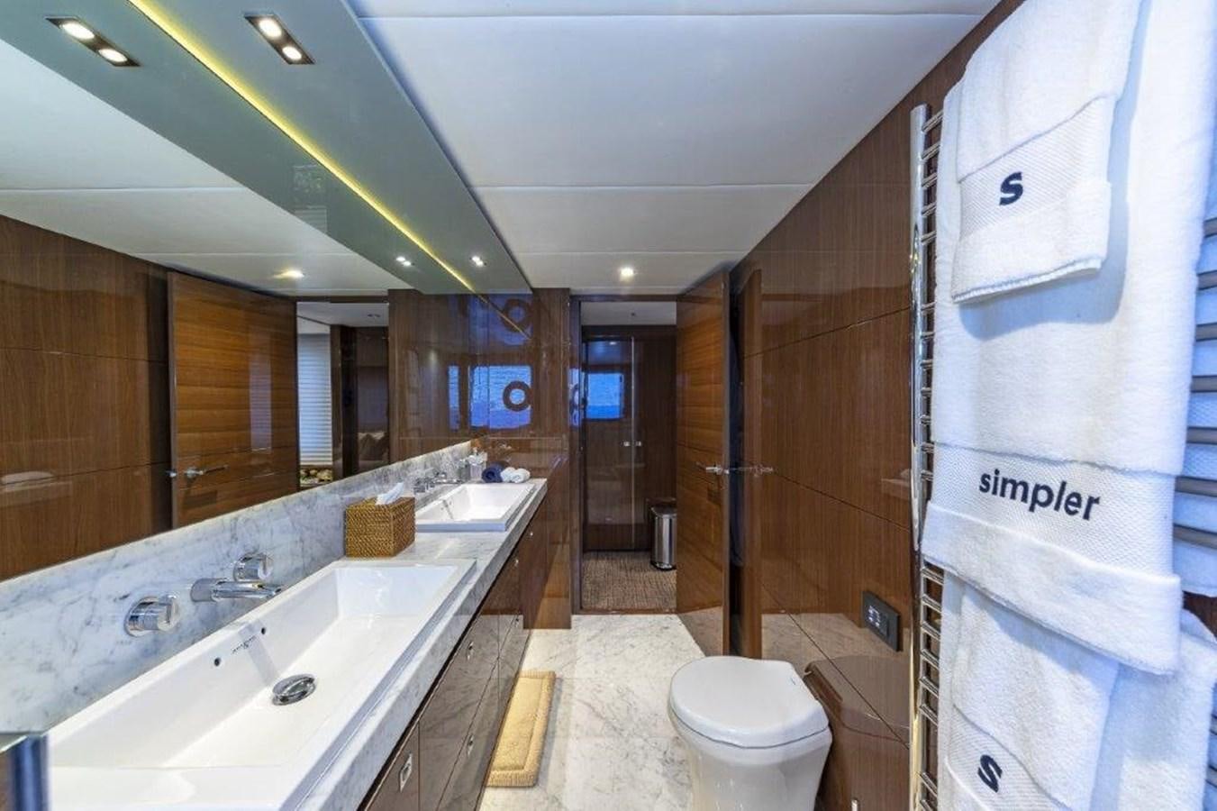 a bathroom with a tub sink and toilet aboard SIMPLER Yacht for Sale