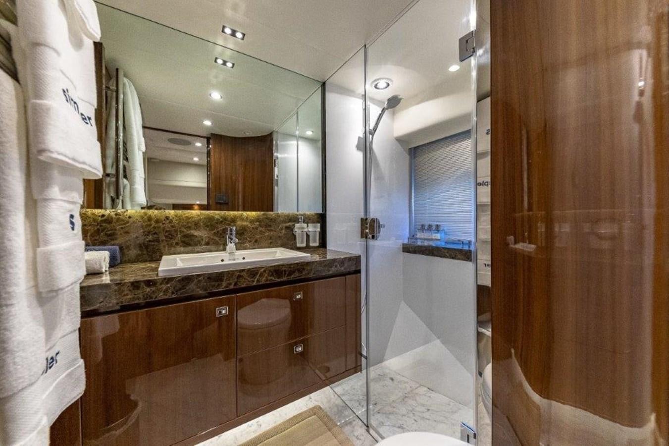 a bathroom with a sink and a mirror aboard SIMPLER Yacht for Sale