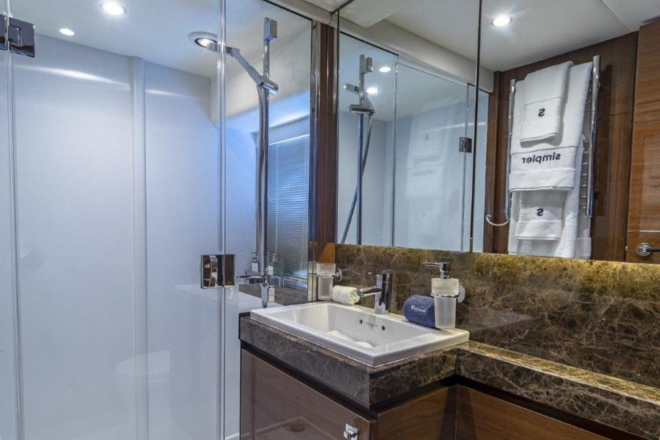 a bathroom with a large glass shower aboard SIMPLER Yacht for Sale
