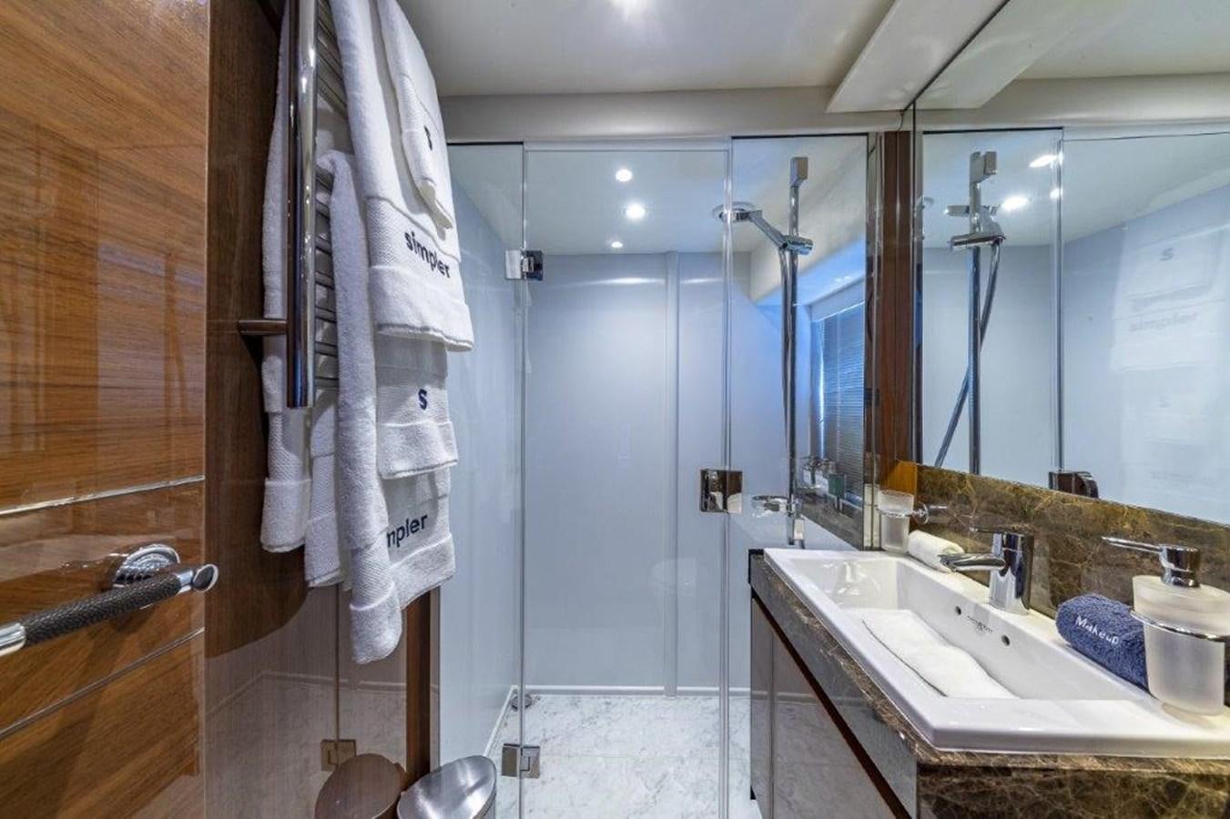 a bathroom with a sink and a mirror aboard SIMPLER Yacht for Sale