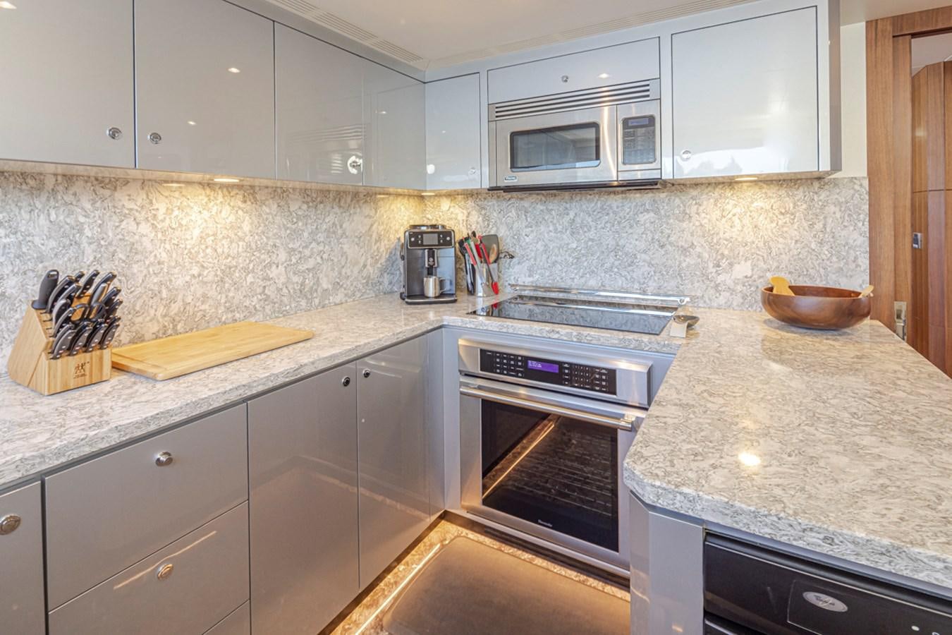 a kitchen with a stove and microwave aboard LANIKAI Yacht for Sale