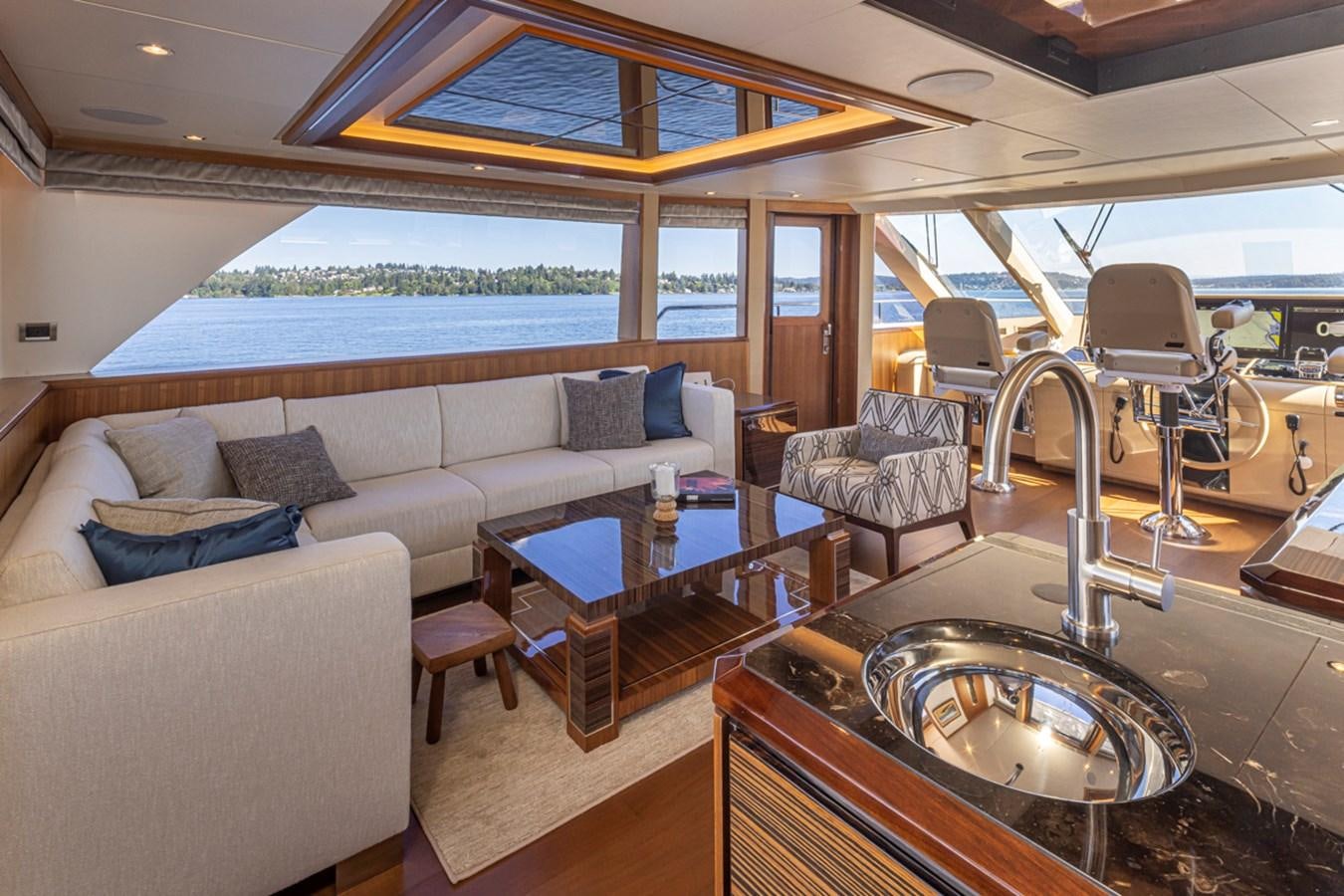a living room with a large table and chairs aboard LANIKAI Yacht for Sale
