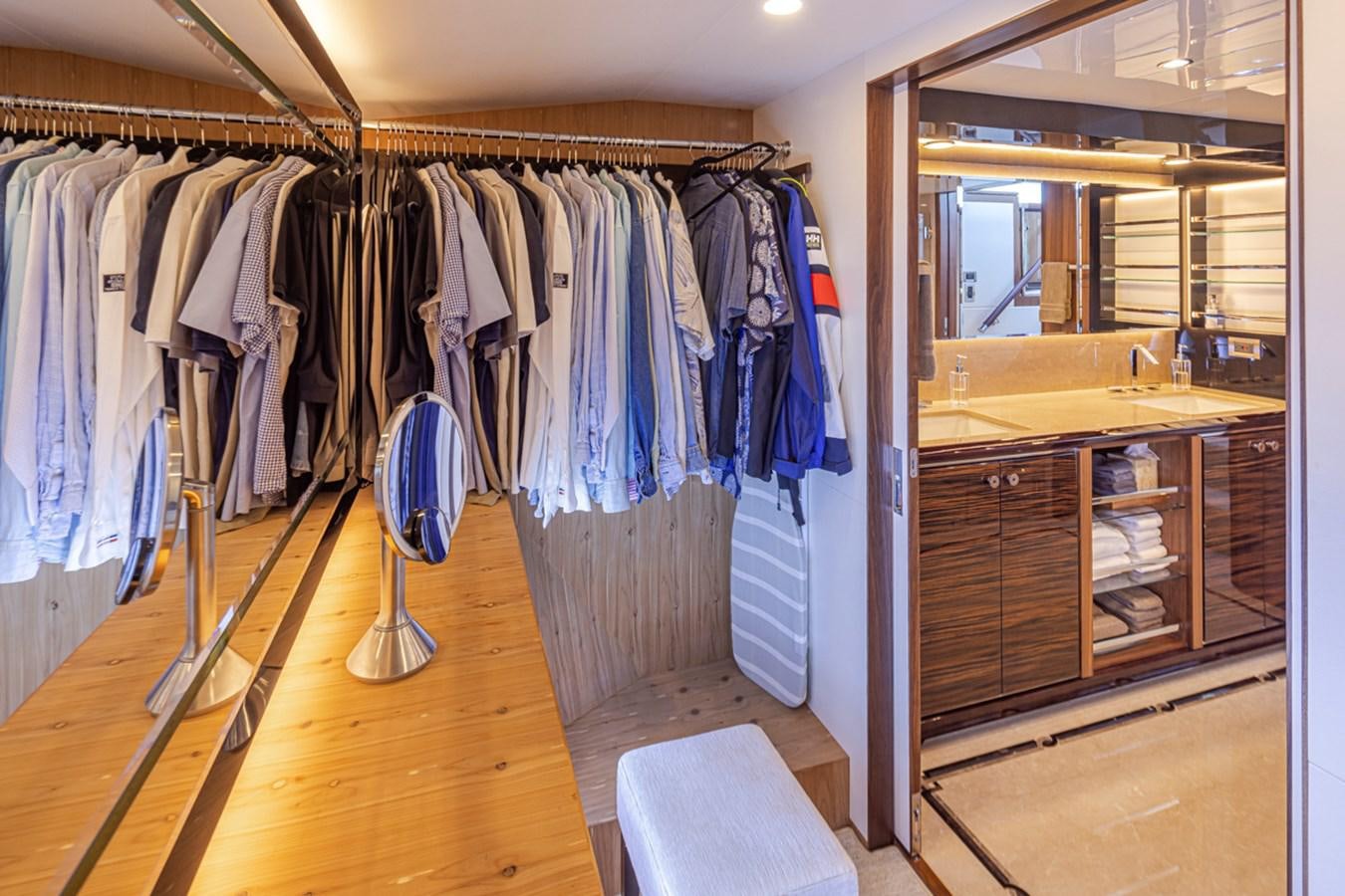 a closet with clothes on the wall aboard LANIKAI Yacht for Sale