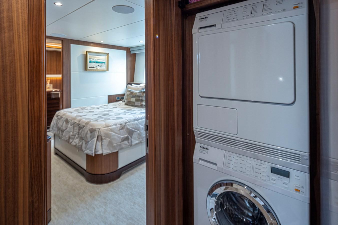 a bedroom with a washing machine aboard LANIKAI Yacht for Sale