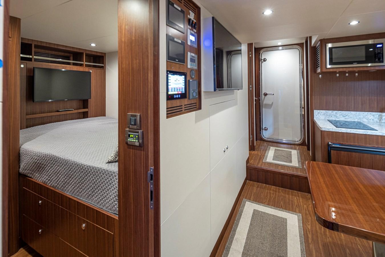 a room with a bed and a desk aboard LANIKAI Yacht for Sale