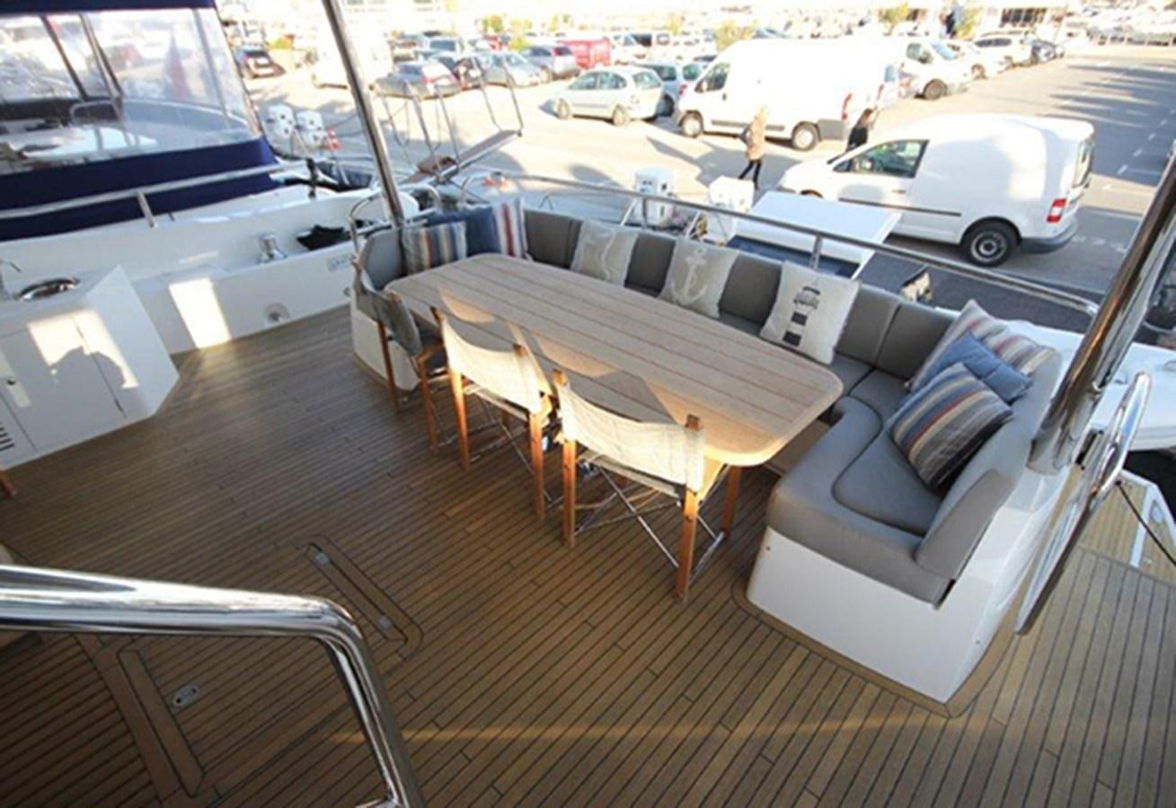 a table and chairs on a deck aboard MIBOWT Yacht for Sale