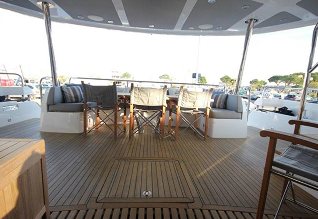 a room with a table and chairs aboard MIBOWT Yacht for Sale