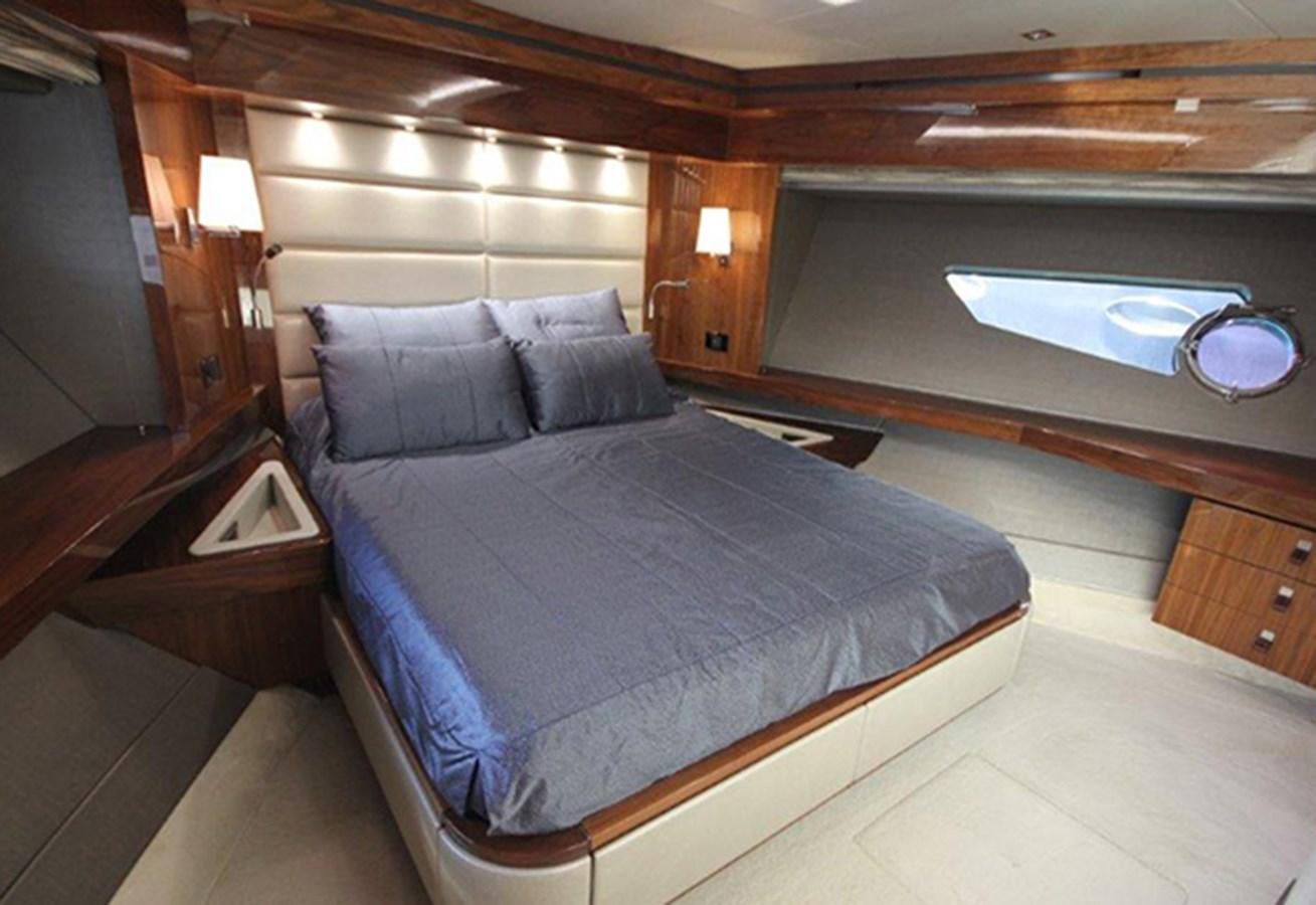 a bed with a blue comforter aboard MIBOWT Yacht for Sale