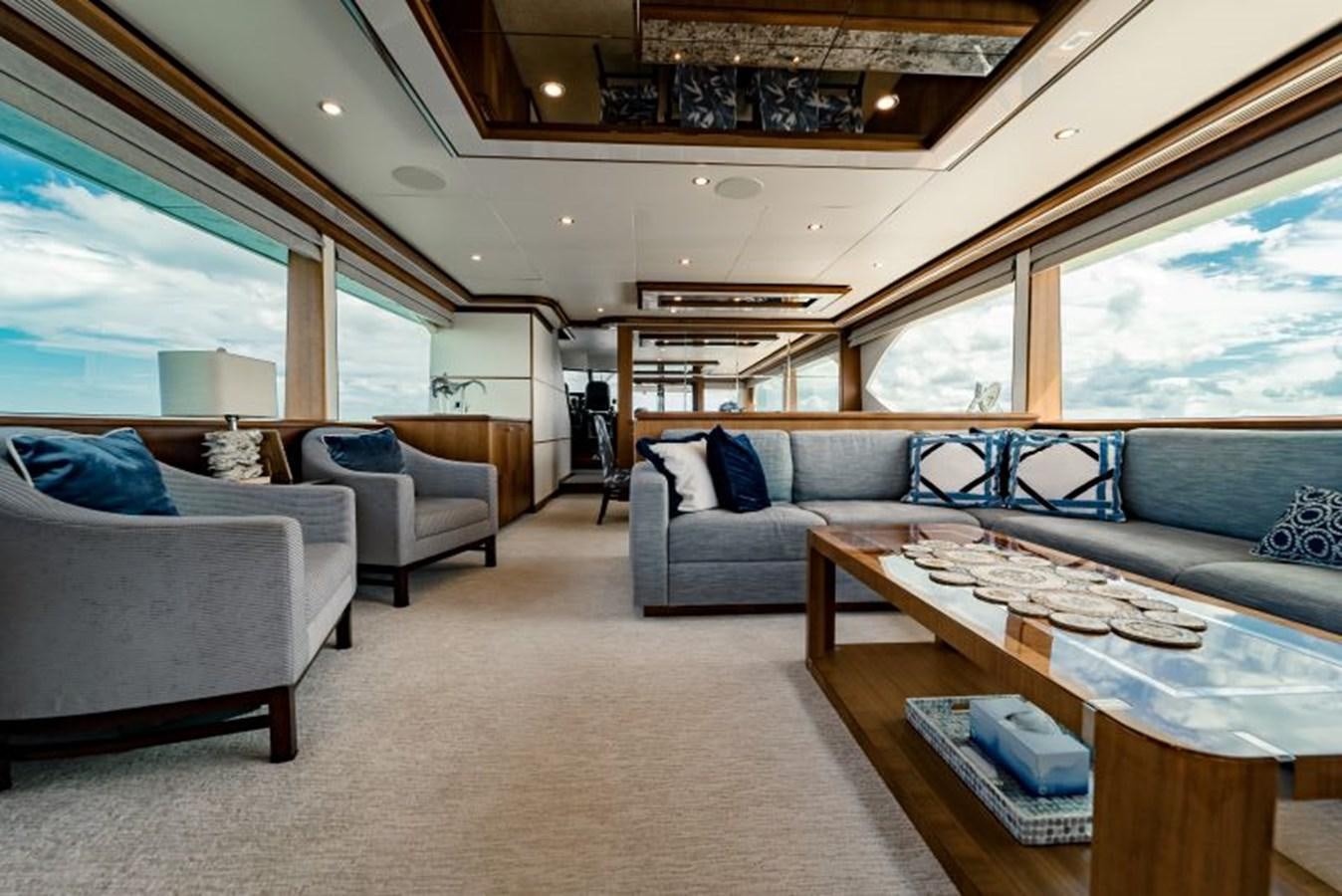 a living room with a table and couches aboard SWEET SALT Yacht for Sale