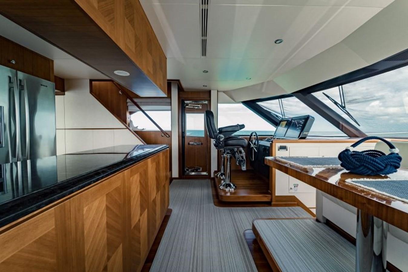 a room with a wood floor and a desk with a computer on it aboard SWEET SALT Yacht for Sale
