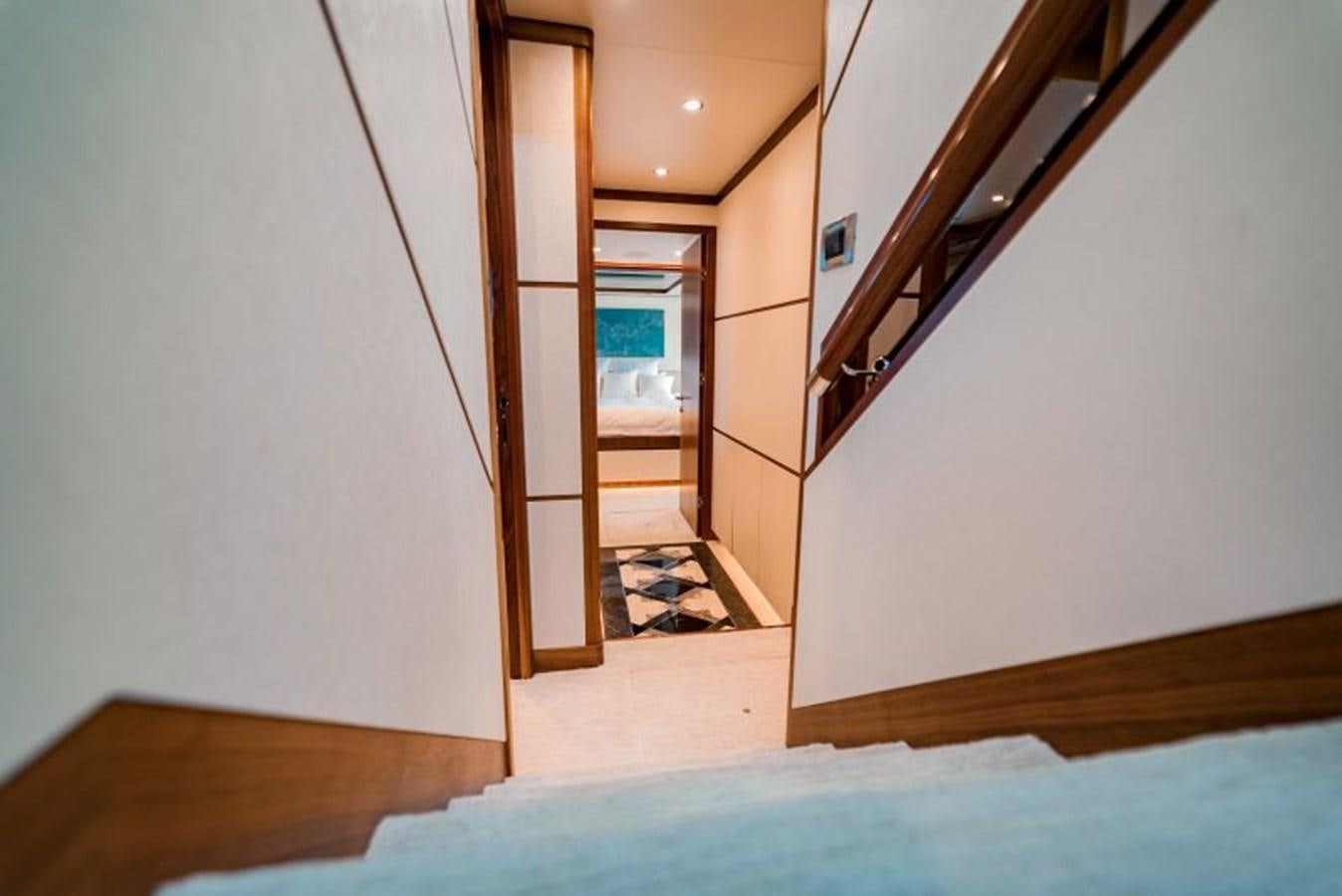 a hallway with a door and a staircase aboard SWEET SALT Yacht for Sale