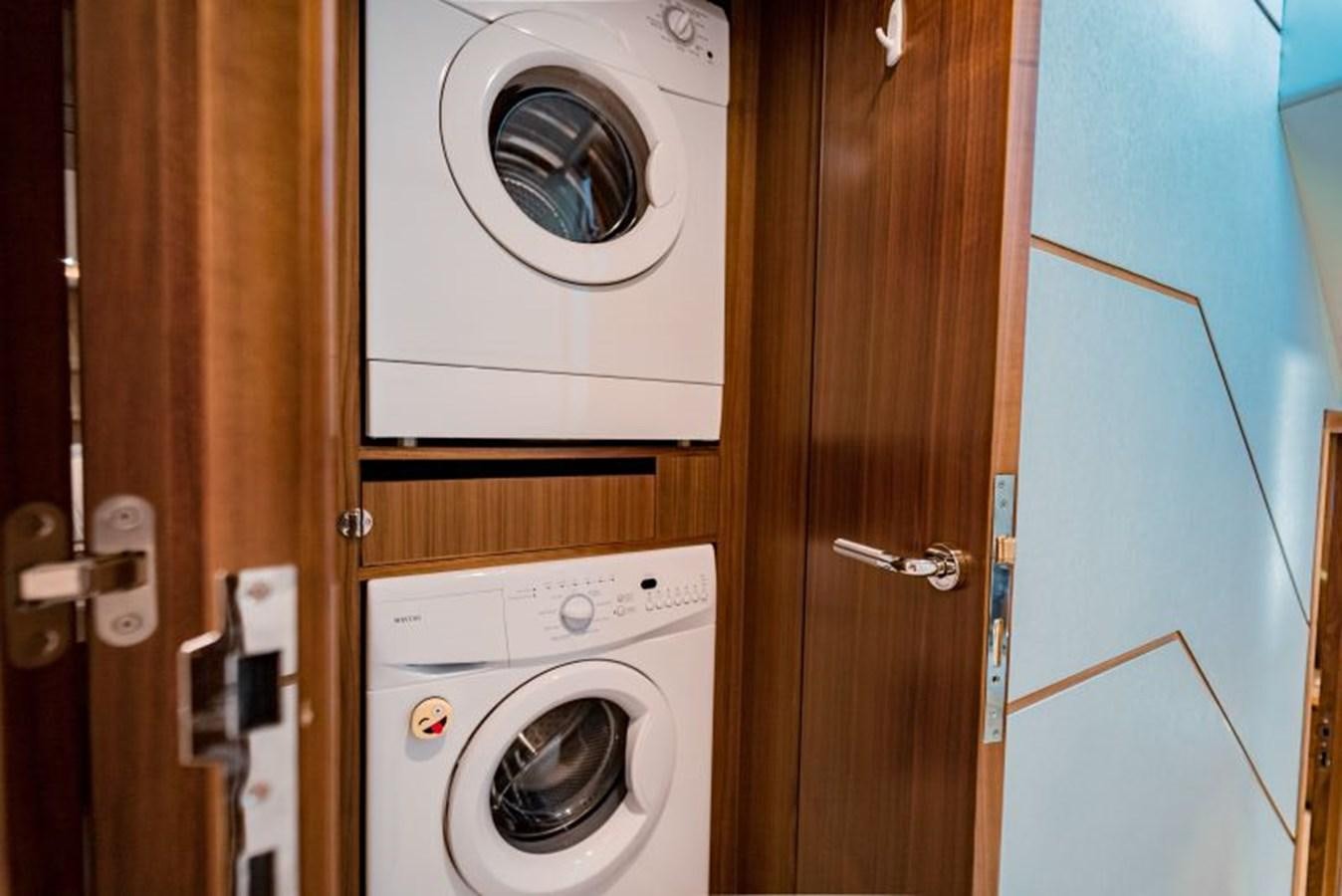 a closet with a washing machine and dryer aboard SWEET SALT Yacht for Sale