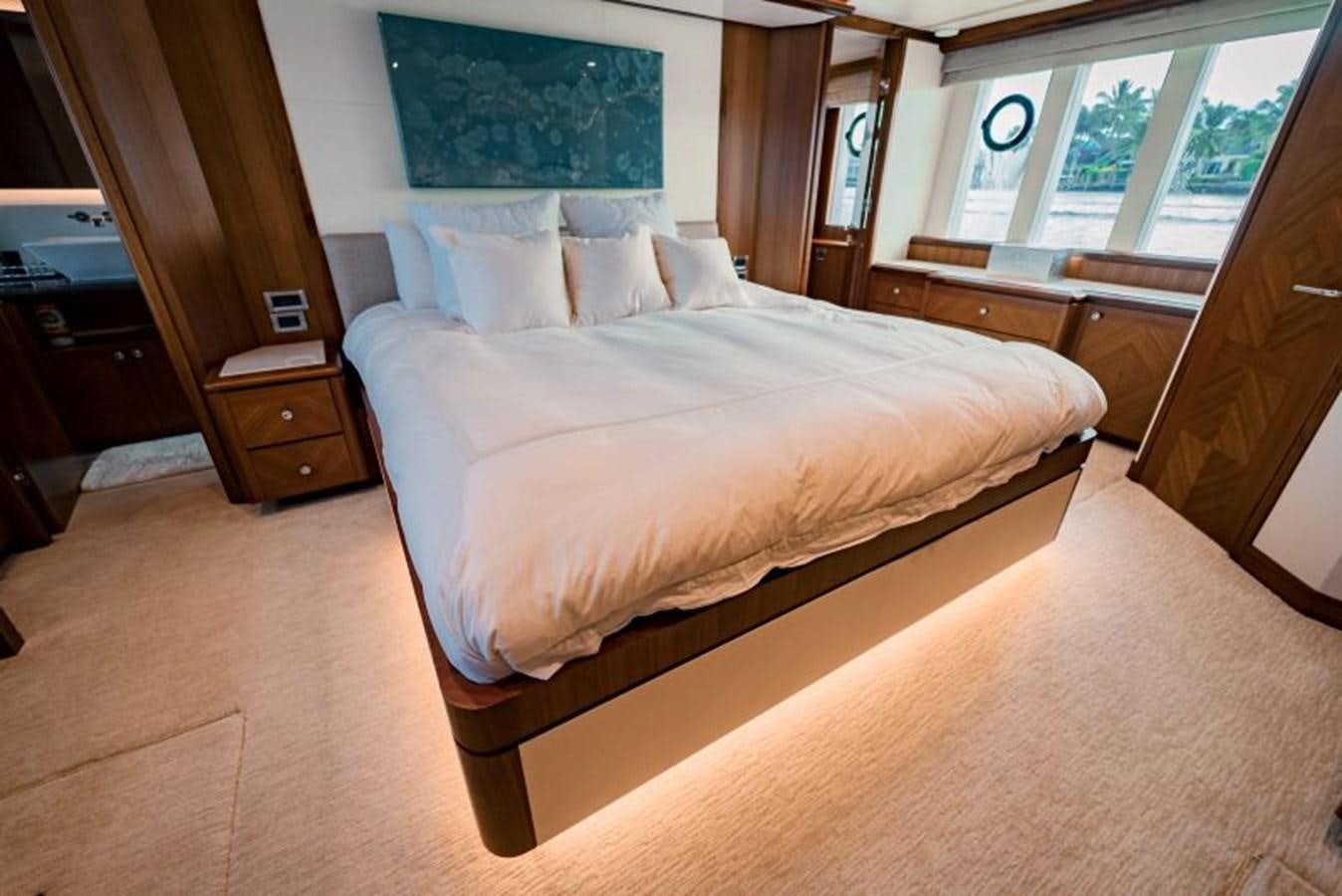 a bed with a white comforter aboard SWEET SALT Yacht for Sale