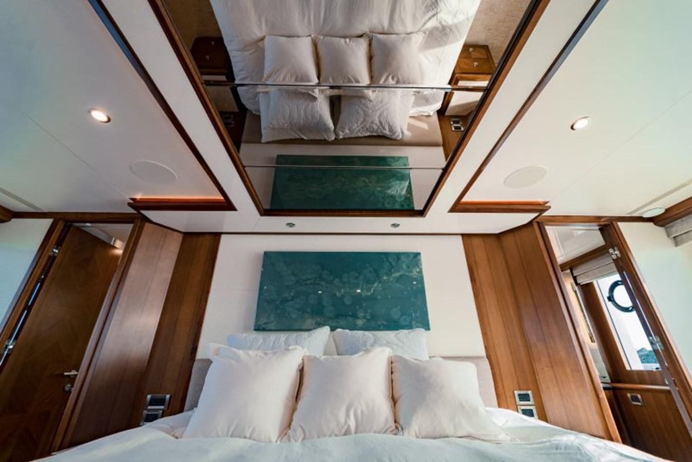a bed with a blue pillow aboard SWEET SALT Yacht for Sale