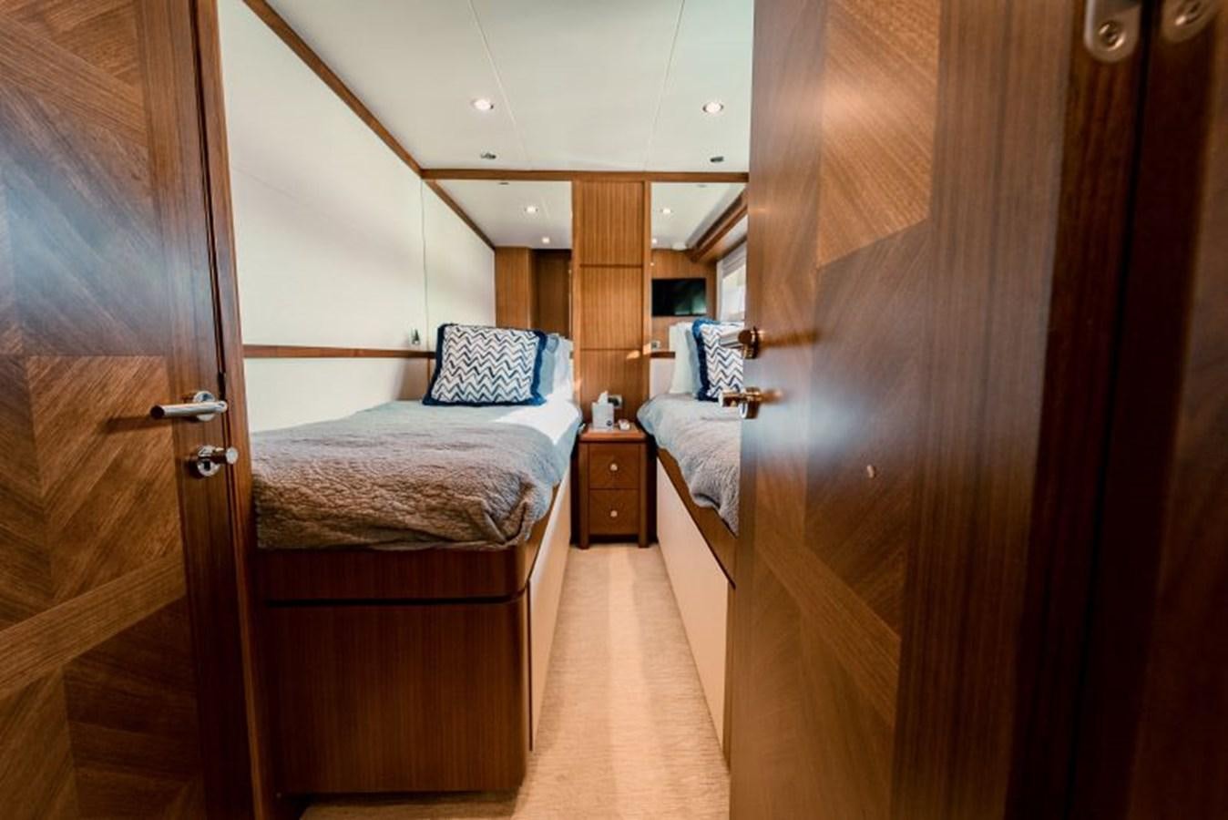 a bedroom with a bed and a wood door aboard SWEET SALT Yacht for Sale